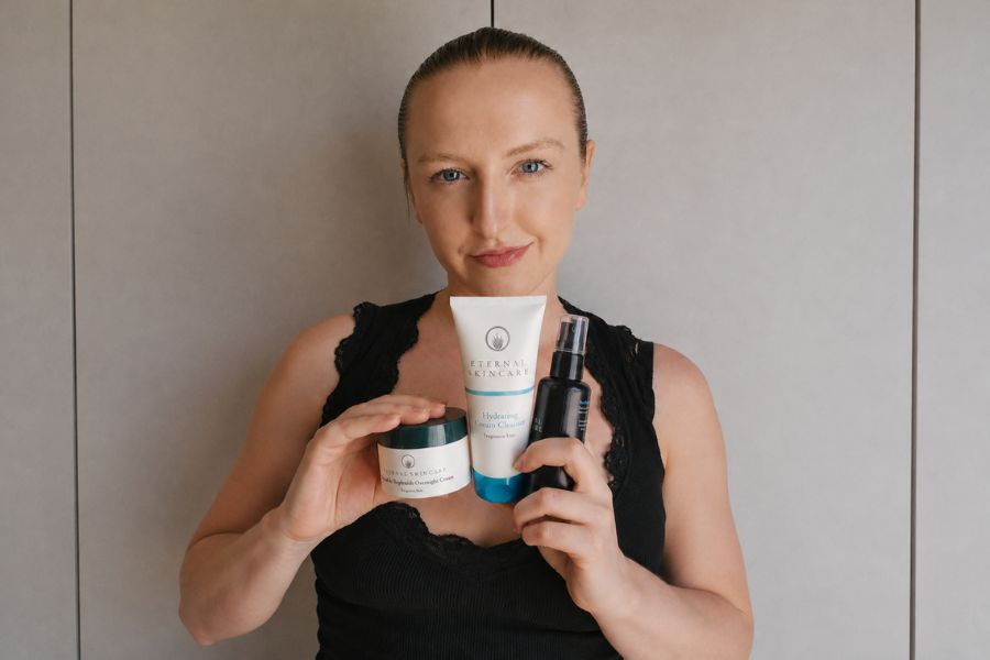 Abigail holding the Eternal Skincare products she uses in her skincare routine